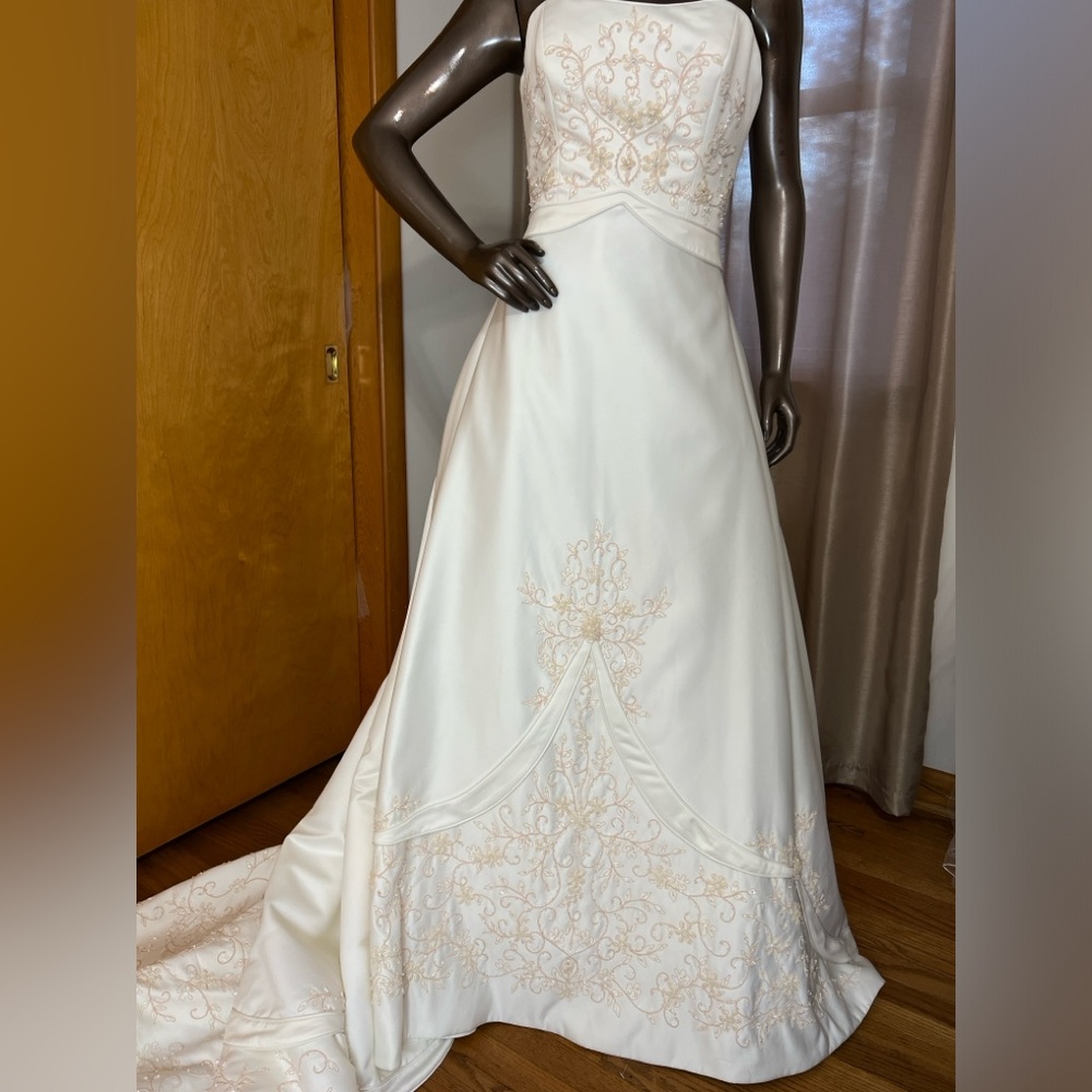 Ivory embroidered bodice with sweat heart neckline and cathedral length train.